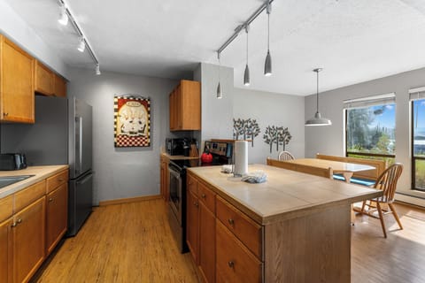 Full kitchen with stainless steel appliances.