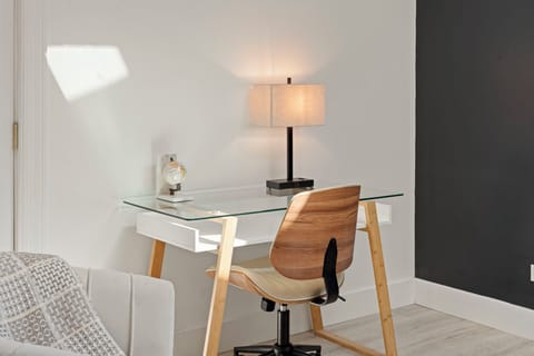 a designated workspace with glass table and side light