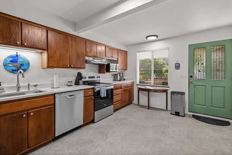 A fully equipped kitchen with stainless appliances and coastal touches makes meal prep easy while keeping the charm of home.