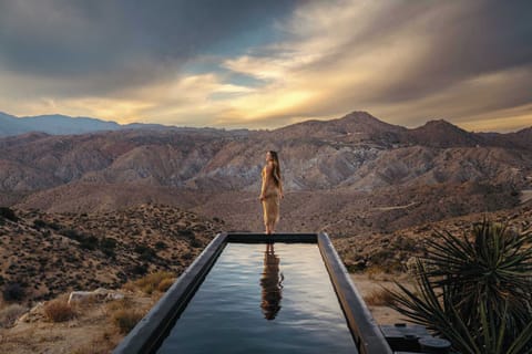 Relax and enjoy the desert views from the pool. Photo taken prior to installation of city-required pool safety fencing.