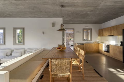 The bespoke, well-equipped kitchen and indoor dining area, up a step from the living area.