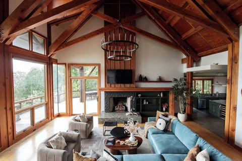 Inhale the breathtaking mountain views from floor to ceiling windows from couch.