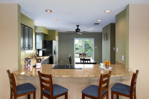 A bar with seating for four overlooks the kitchen and dining area, making it easy to cook, serve, and connect.