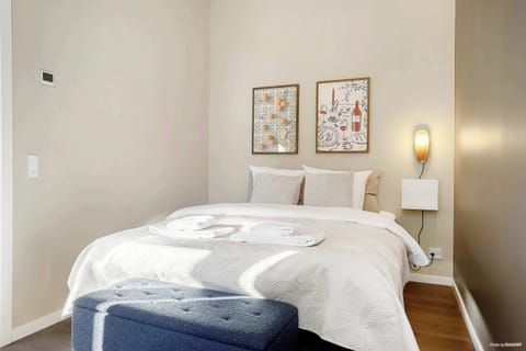 Double bedroom with blackout curtains, built-in closets and a comfortable queen bed