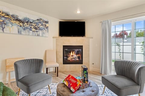 Warm and inviting living room with fireplace, board games, and comfy seating