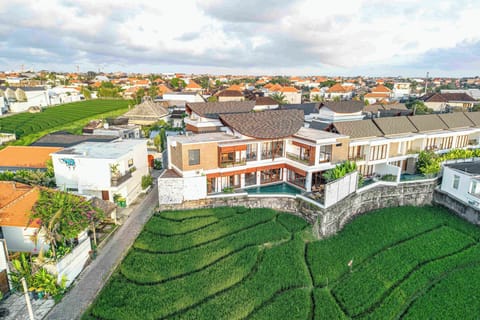 Aireal shoot of the villa with the  surrounding rice fields
