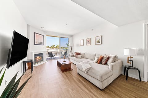 Bright and spacious living area with 65" Smart TV overlooking the Marina.