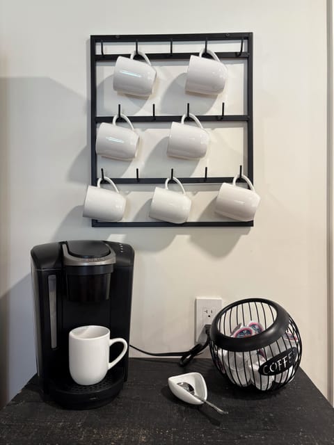 The kitchen coffee station has a Kurig coffee maker, coffee pods, creamer, etc.