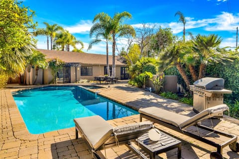 Spend sun-drenched days lounging by the sparkling pool or fire up the large grill for an al fresco feast. As evening falls, this inviting outdoor space transforms with charming string lights, perfect for memorable nights under the stars.