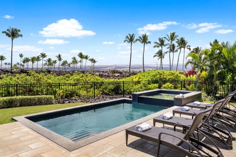 Relax by the private pool with golf course views and Mauna Kea in the distance.