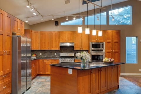 Stainless steel appliances and breakfast bar.