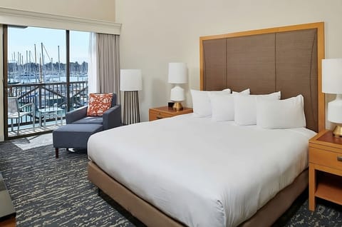Recharge in a serene king room with cozy seating.