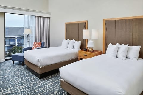 Unwind in bright double-queen comfort beside a sunny balcony.