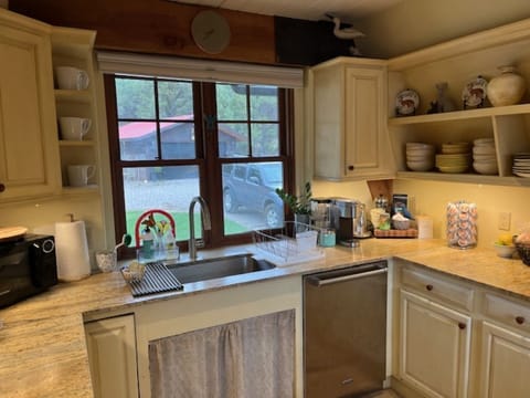 Charming kitchen with sink view to front entry to home