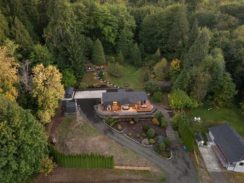 Aerial twilight view showcasing the home’s warm light and vast, serene surroundings