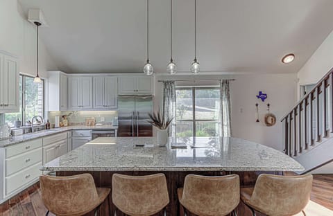 Chef's kitchen with granite counters and stainless appliances 