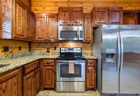 Rustic charm meets comfort inside, with stone fireplace, warm wood, and space to gather after a day exploring.