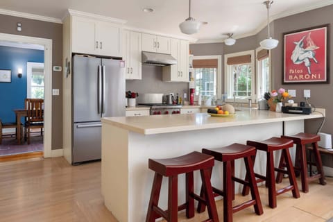 The kitchen has a breakfast counter, complete with stools.