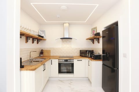 Modern appliances, sleek finishes, and a coffee pod machine ready to go.