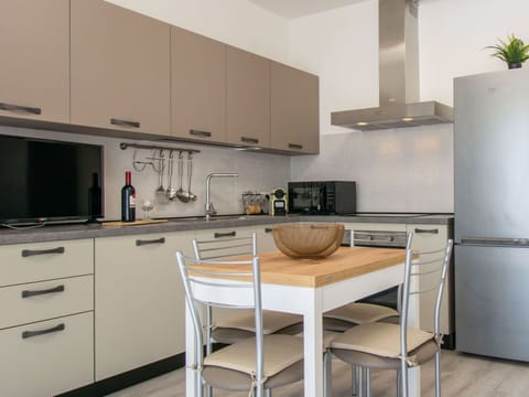 Furniture, Kitchen, Cabinetry, Countertop, Kitchen Appliance, Interior Design, Flooring, Wood, Major Appliance, Chair