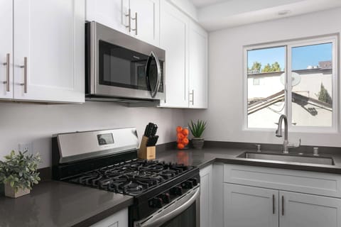 Kitchen view featuring gas stove and ample counter space