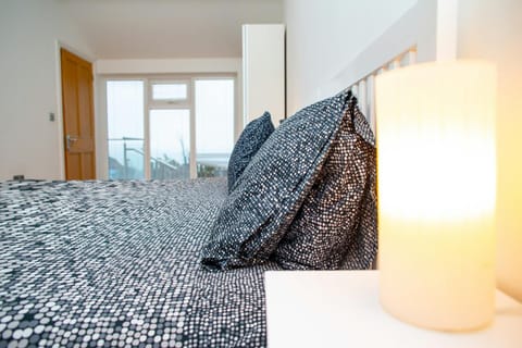 Queen size bedroom with sea views through the doors