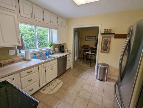 The kitchen offers many fine amenities including dishes, pots/pans, a stove and fridge, microwave, a pantry, toaster, Nutri Bullet, and more.