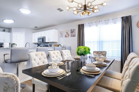 Spacious dining table that sits 8 with full tableware and silverware included.