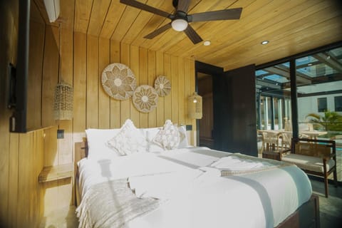 This charming bedroom offers a comfortable escape with its own deck access, making it an ideal spot to relax, recharge, and soak in the beauty of the island.