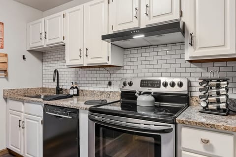 Kitchen: Main floor, drip coffee maker, blender, toaster, cooking utensils, tableware