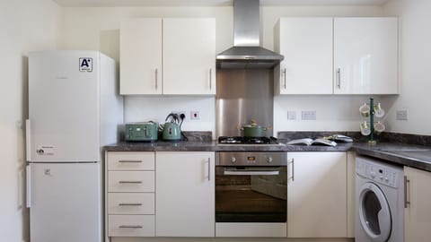 A fridge/freezer, oven and hob, washing machine and a dishwasher are all here.