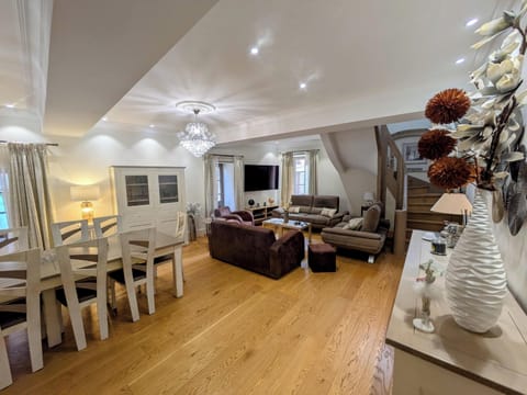 A large living room with Smart TV and sofas for relaxing