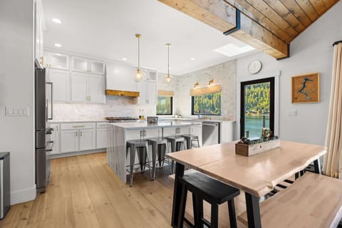 Bright, open dining and kitchen space designed for connection — where conversation flows as easily as the view outside.
