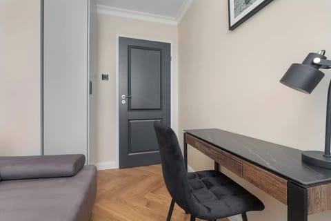The bedroom featuring a functional workspace with a desk and chair.