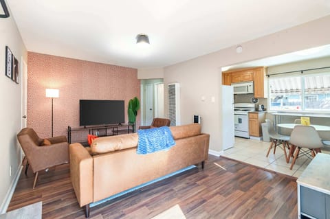 Bright and airy setup with sofa, coffee table, and wooden flooring for a homey feel.
