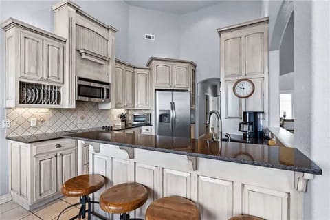 Cook together in the fully stocked chef’s kitchen—features a large island, stainless appliances & dining for everyone.