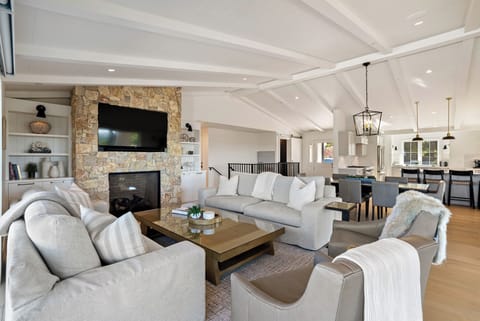 The living room features a fireplace, TV and ample seating. (Main house)