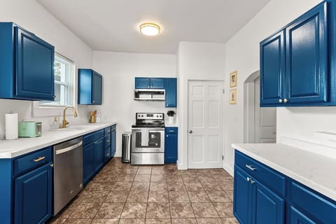 Spacious white counters make this kitchen ideal for cooking memorable meals to share with your whole group.
