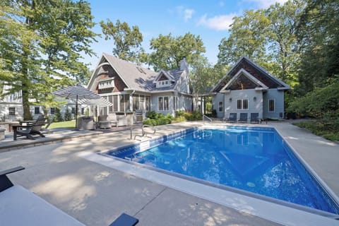 In-ground pool and outdoor cooking area create a relaxing space