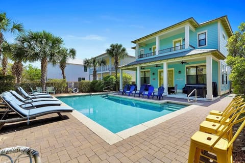 Sand Pebble—your perfect group getaway that SLEEPS 20! Just steps from beach access, this stunning retreat includes a FREE golf cart. Unwind in the backyard oasis with a heated poo, outdoor kitchen, and lounge seating!