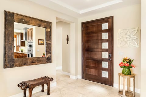 Oversized wood door entry to Oasis Kona. Easy keypad entry.