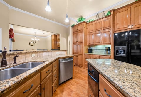 Gourmet kitchen with stainless appliances and double ovens.