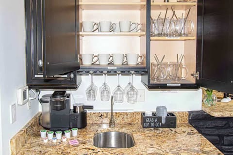 Whether it’s a morning coffee or a nightcap, this built-in bar is ready for both — stocked with mugs, glassware, and everything you need to start or end your day right.