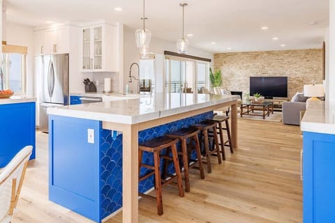 Additional seating for seven at the kitchen counter with sleek bar stools.