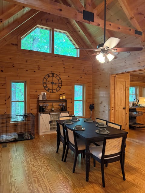 Dining area with wine/coffee bar, tall ceilings, and large windows