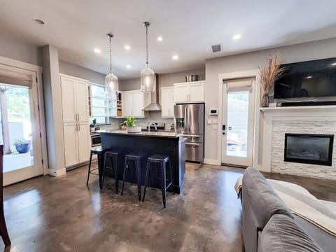 Easy flow from the kitchen to the living, dining, backyard, and screen porch.