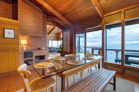 Dining area with large windows overlooking the ocean view.