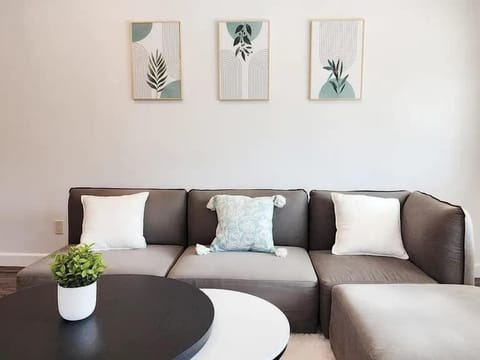 Relax in this sun-filled space with a comfy sectional and modern décor, perfect for movie nights or quiet mornings.