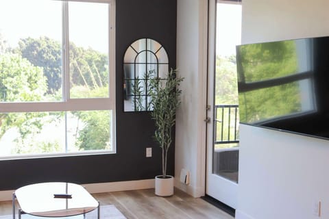 Spacious living room with a 65" Smart TV with preloaded access to Netflix, Hulu, and Disney+, all set up for your enjoyment.