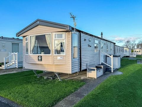 Cozy exterior with private outdoor seating and green lawn